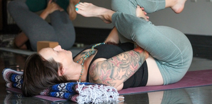 Woman doing yoga pose on her back