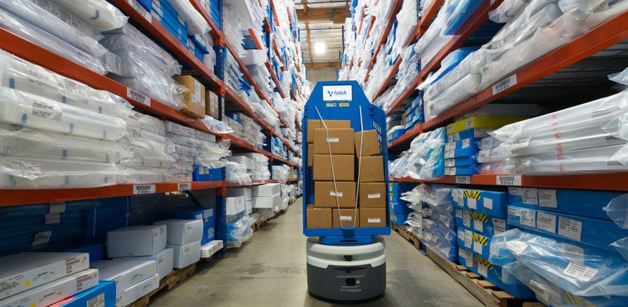 A Fetch robot moves boxes inside a RK Logistics warehouse