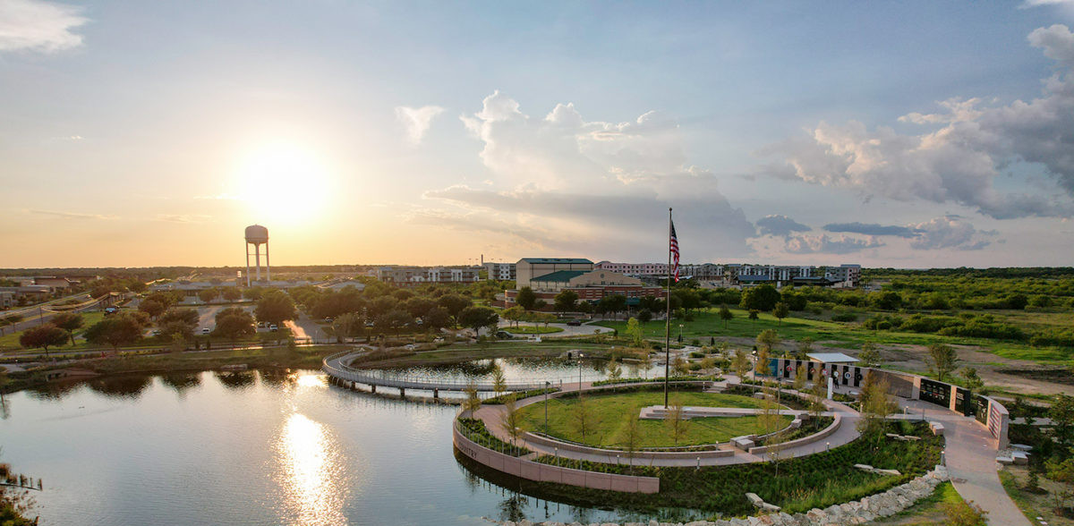 View of Kyle, Tx's Heroes Memorial Park at sunset with watertower in background