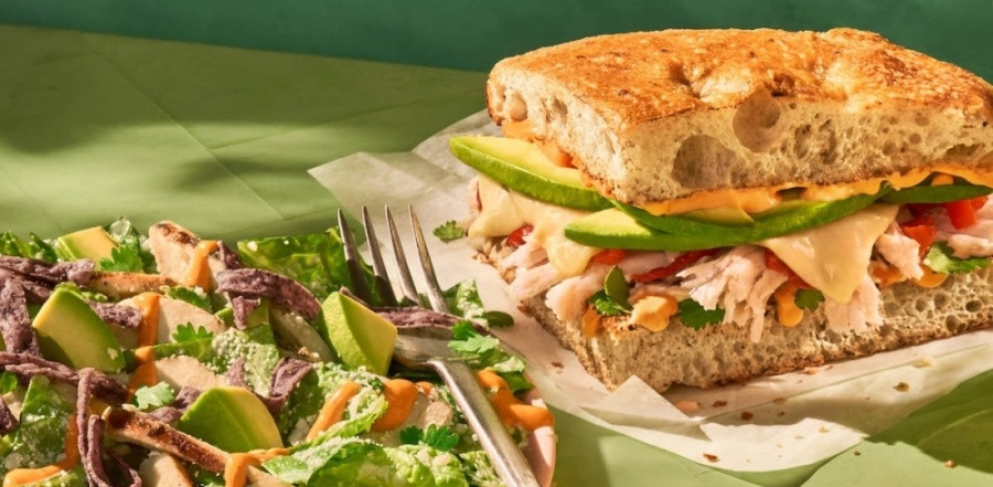 sandwich and salad with fork between them